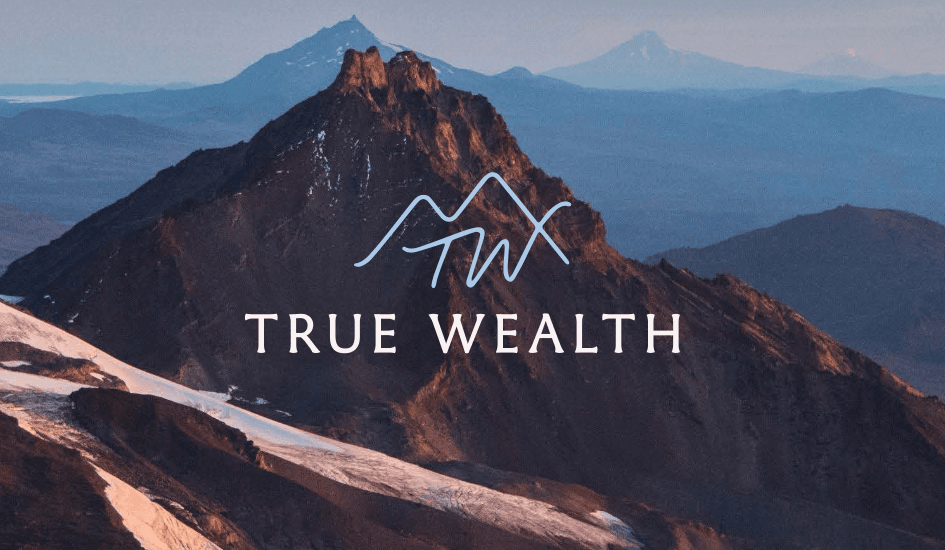 True Wealth logo, a pale blue mountain mark over the name on a photograph of a snowy peak
